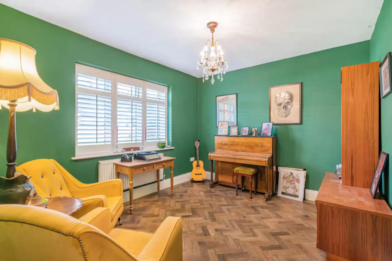 Bromley Retreat green sitting room with piano and reading chair