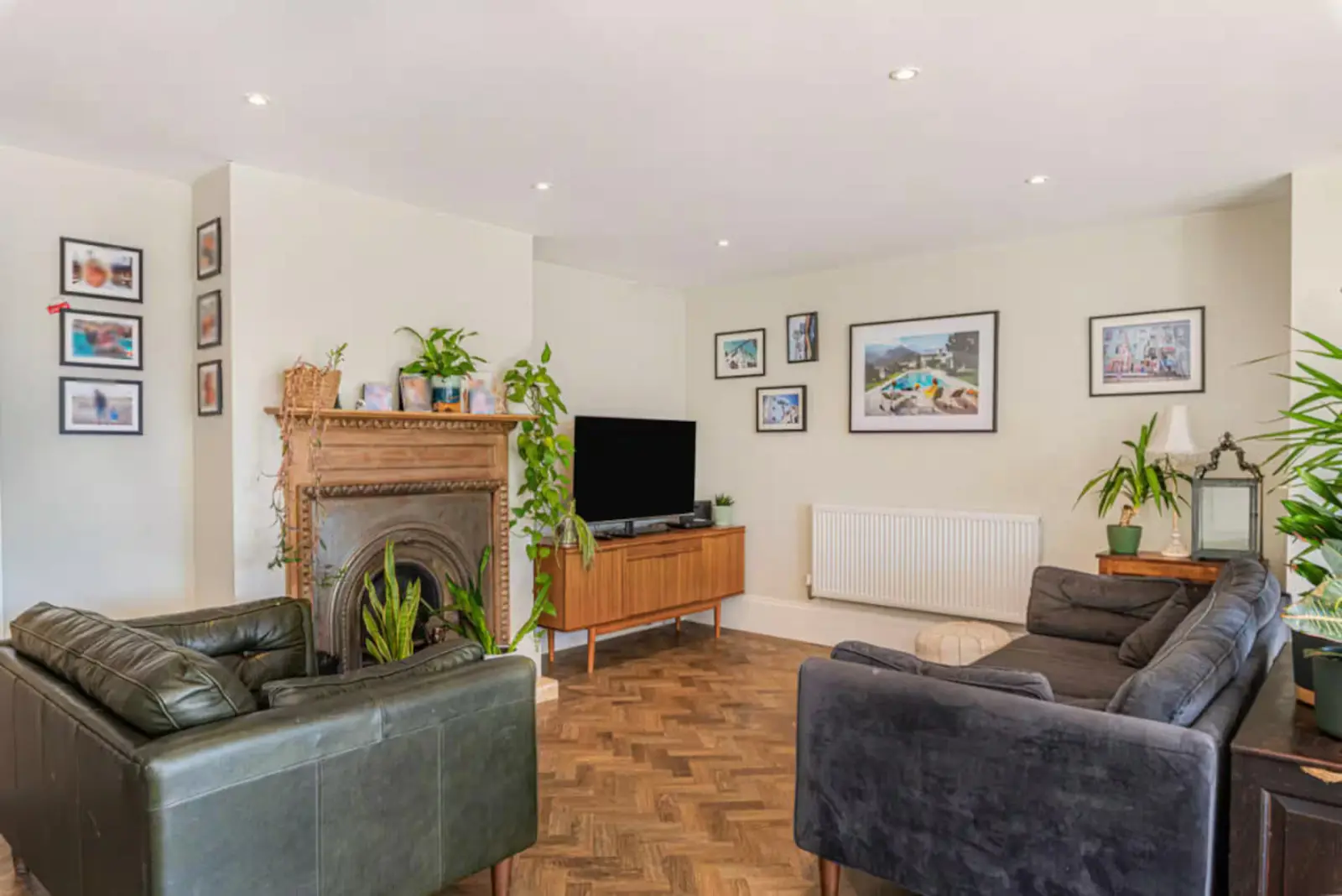 Bromley Retreat lounge with fireplace and greenery